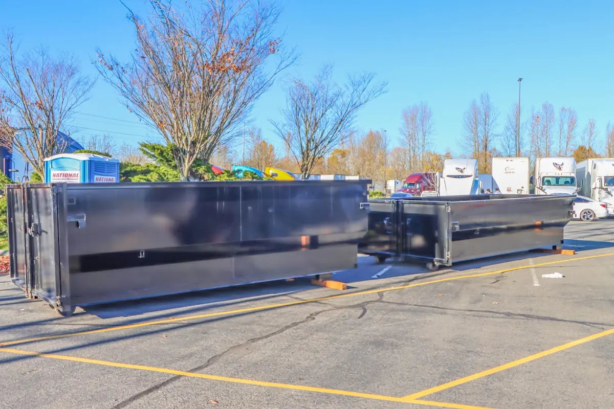 Professional dumpster rental service with roll-off container on residential driveway in Michigan City